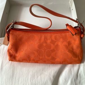 Coach orange with silver zipper purse. New. Clean no marks inside.